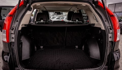 Empty black SUV cargo trunk with open hatchback and red taillights visible from rear view