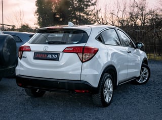 White Honda HR-V compact SUV photographed from rear three-quarter view in a dealership lot