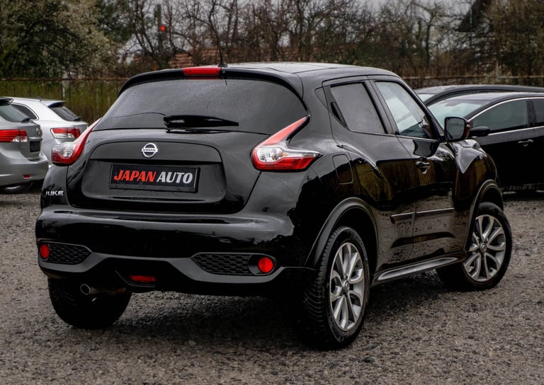 Black Nissan Juke at dealership with open door