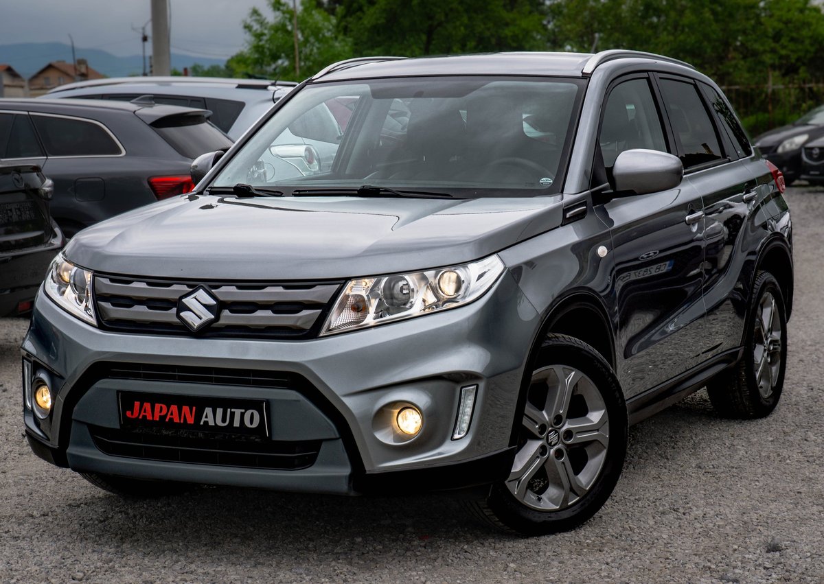 Silver Suzuki Vitara compact SUV parked on lot with JAPAN AUTO license plate visible