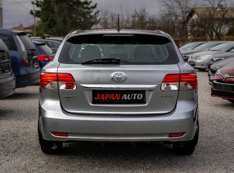 Silver Toyota Matrix hatchback viewed from the rear at a used car dealership lot with other vehicles in the background