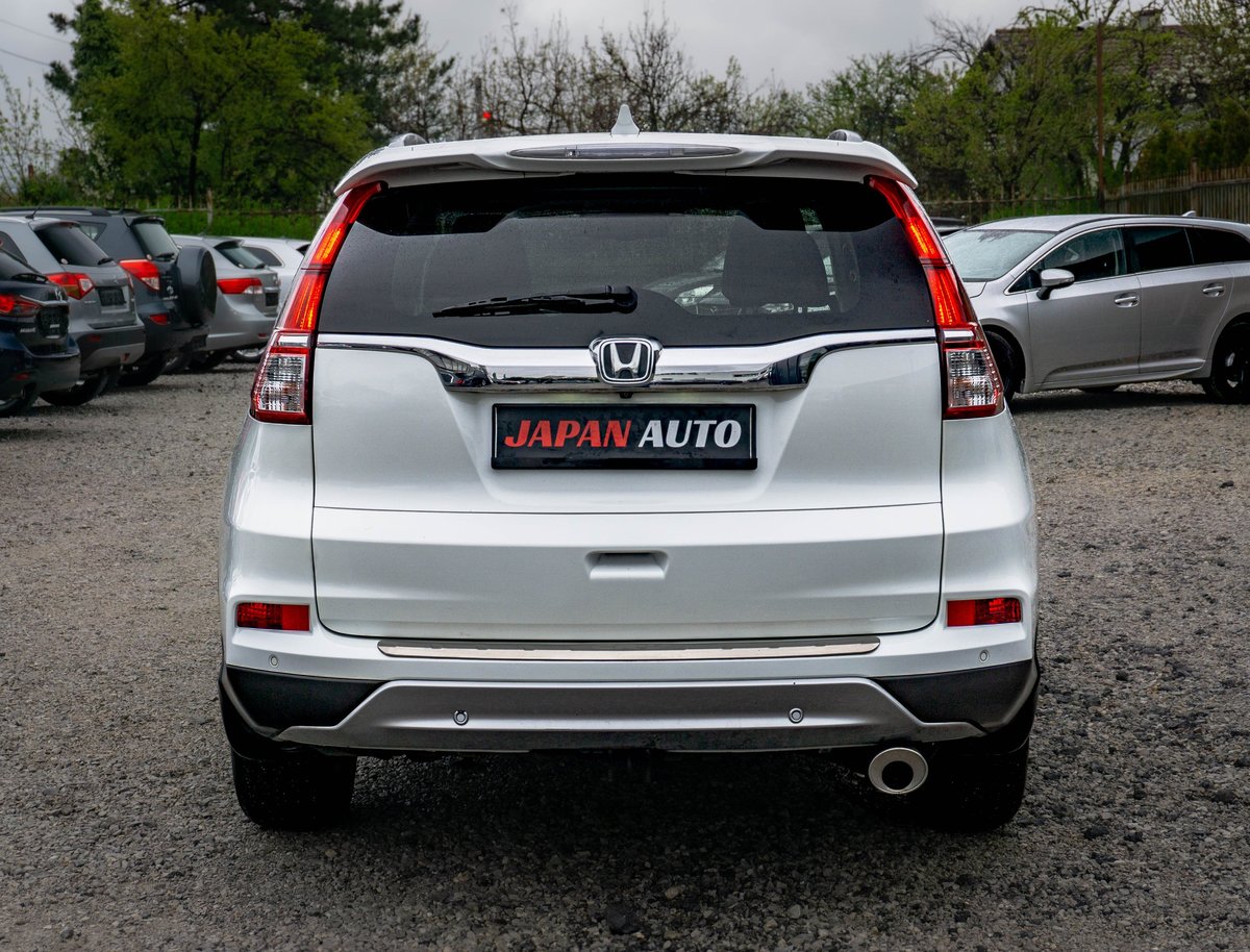 Rear view of white Honda CR-V at Japan Auto dealership with red tail lights and license plate visible