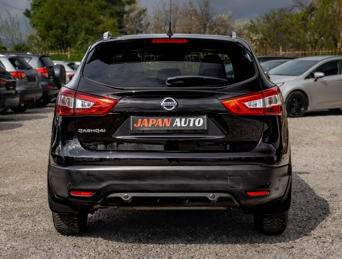 Rear view of a black Nissan Qashqai SUV in a parking lot with Japan Auto branding visible on the bumper