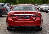 Red Mazda sedan rear view