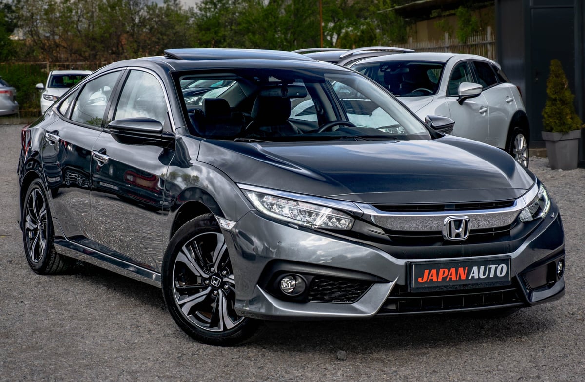 Silver Honda sedan parked at a dealership with Japan Auto license plate visible on front