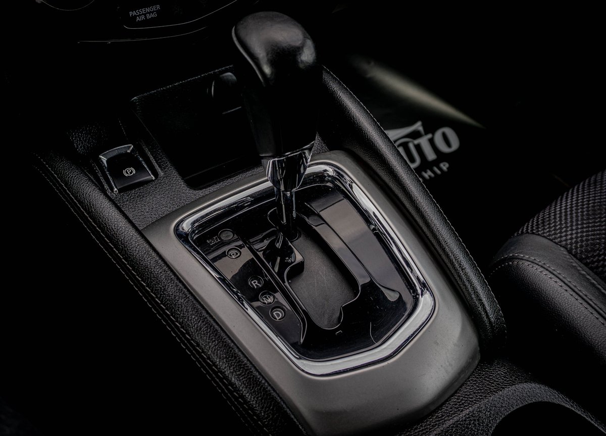 Close-up of a cars automatic gear shift and center console in black and white photography