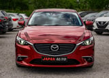 Red Mazda sedan side view