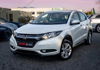 White Honda HR-V SUV displayed at a car dealership lot with Japan Auto signage visible