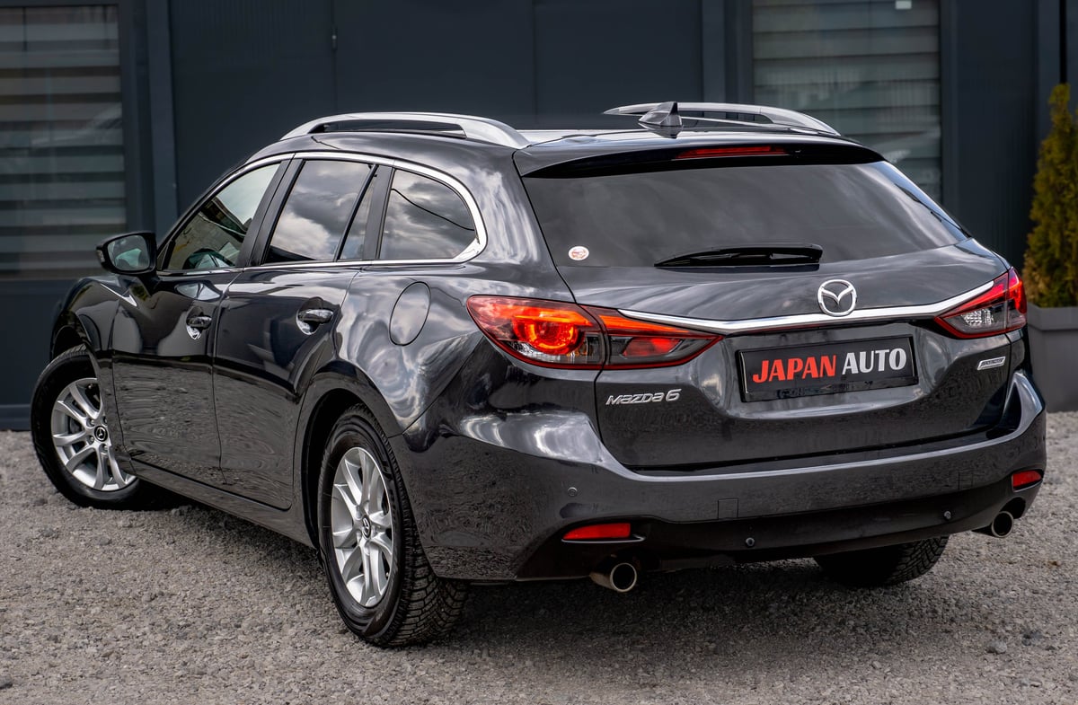 Black Mazda6 station wagon parked outdoors, showing rear and side profile with Japan Auto dealership plate