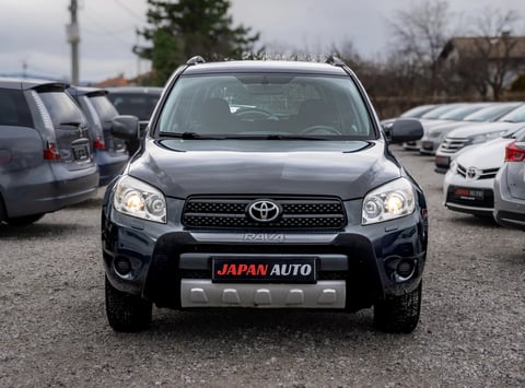 Front view of a black Toyota RAV4 SUV with Japan Auto license plate in a dealership lot