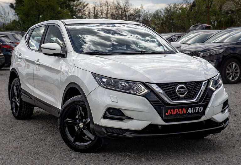 White Nissan Qashqai compact SUV at a dealership with Japan Auto license plate visible