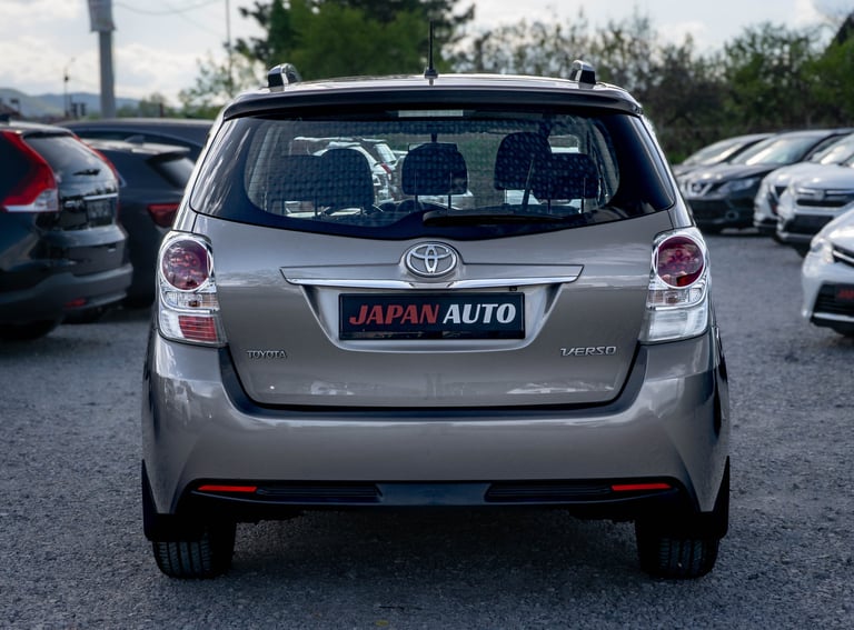 Silver Toyota hatchback rear view in dealership lot with Japan Auto license plate