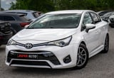 White Toyota sedan parked in a lot