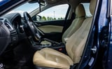Interior of blue sports car with tan leather seats