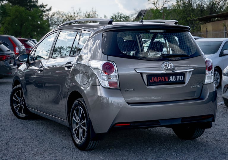Silver Toyota hatchback car parked in a lot with Japan Auto license plate