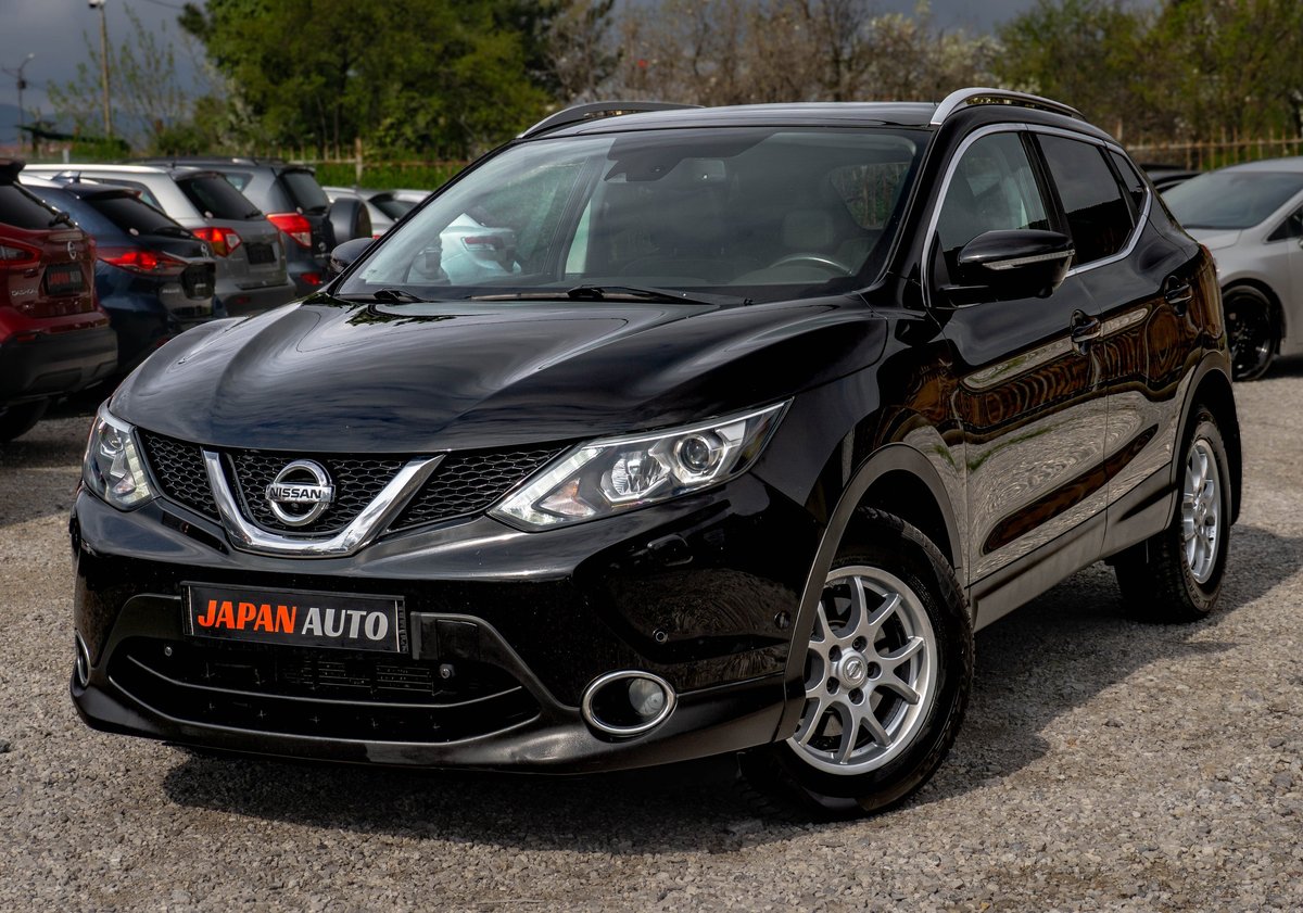Black Nissan Qashqai parked in a lot with Japan Auto branding